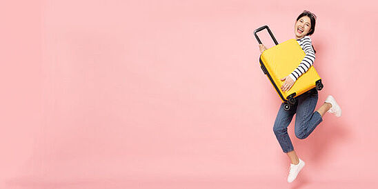 Hardlines Testing Woman holding yellow, hard-sided luggage