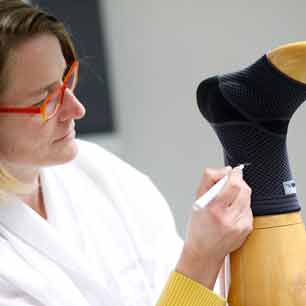 Medical Compression Expert marking medical compression stocking on ankle bust