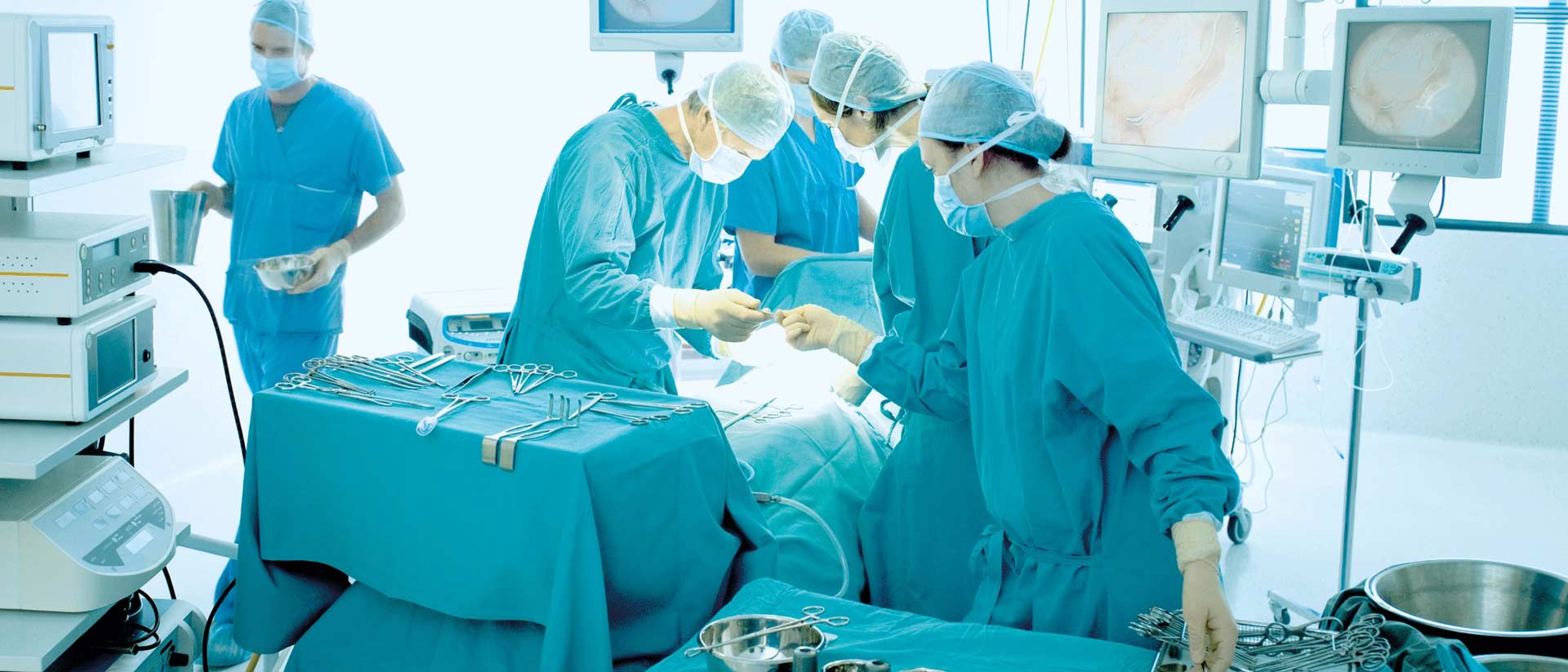 Health-Focused Testing for Medical and Consumer Products Sterile surgical drapes and gowns prepared on instrument table in operating room