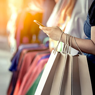 EU - European Commision Shopper holding phone and bags